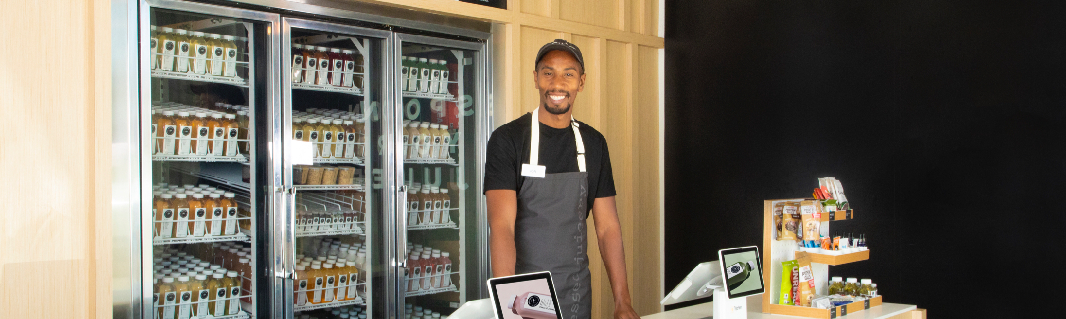 A Pressed Juicery® Employee standing behind a counter.